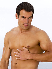 Bronzed and oiled beefy dude showing his rock-tool