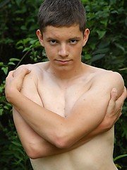 Small twink guy posing naked outdoors