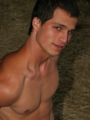 Horny naked twink posing in a barn