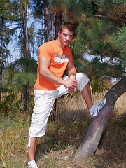 Beefy jock takes off his clothes in the wood