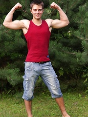 In a luscious outdoor setting, two hunky athletic uncut studs are busy getting down and dirty amongst the wild life