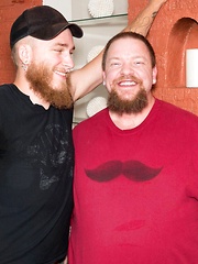 Fat tattooed gay guy with a beard bends over and gets fucked up the ass